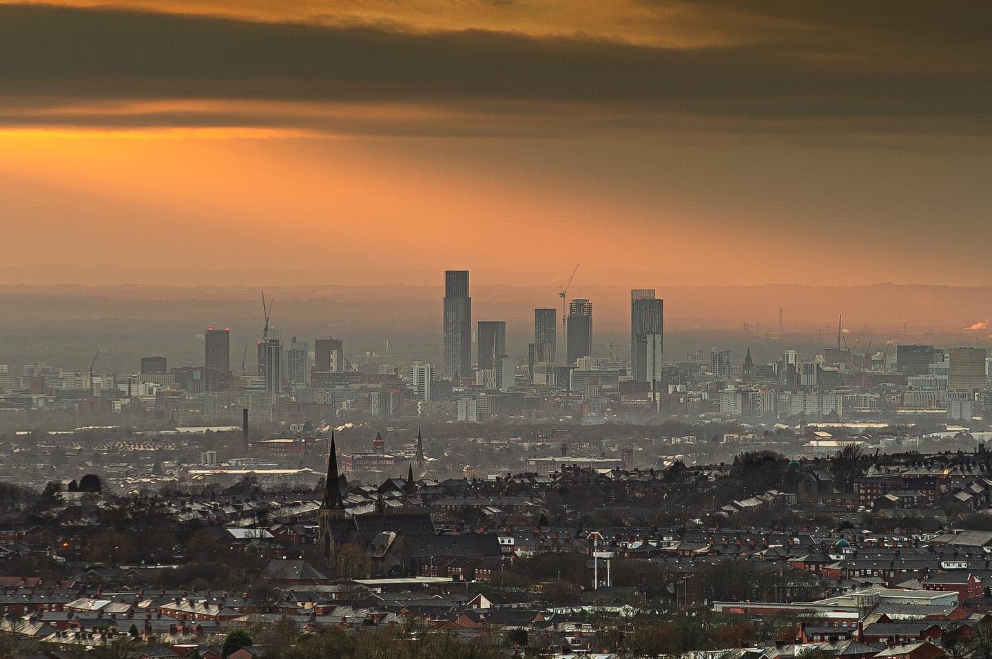 Manchester skyline at sunset from a broad viewpoint