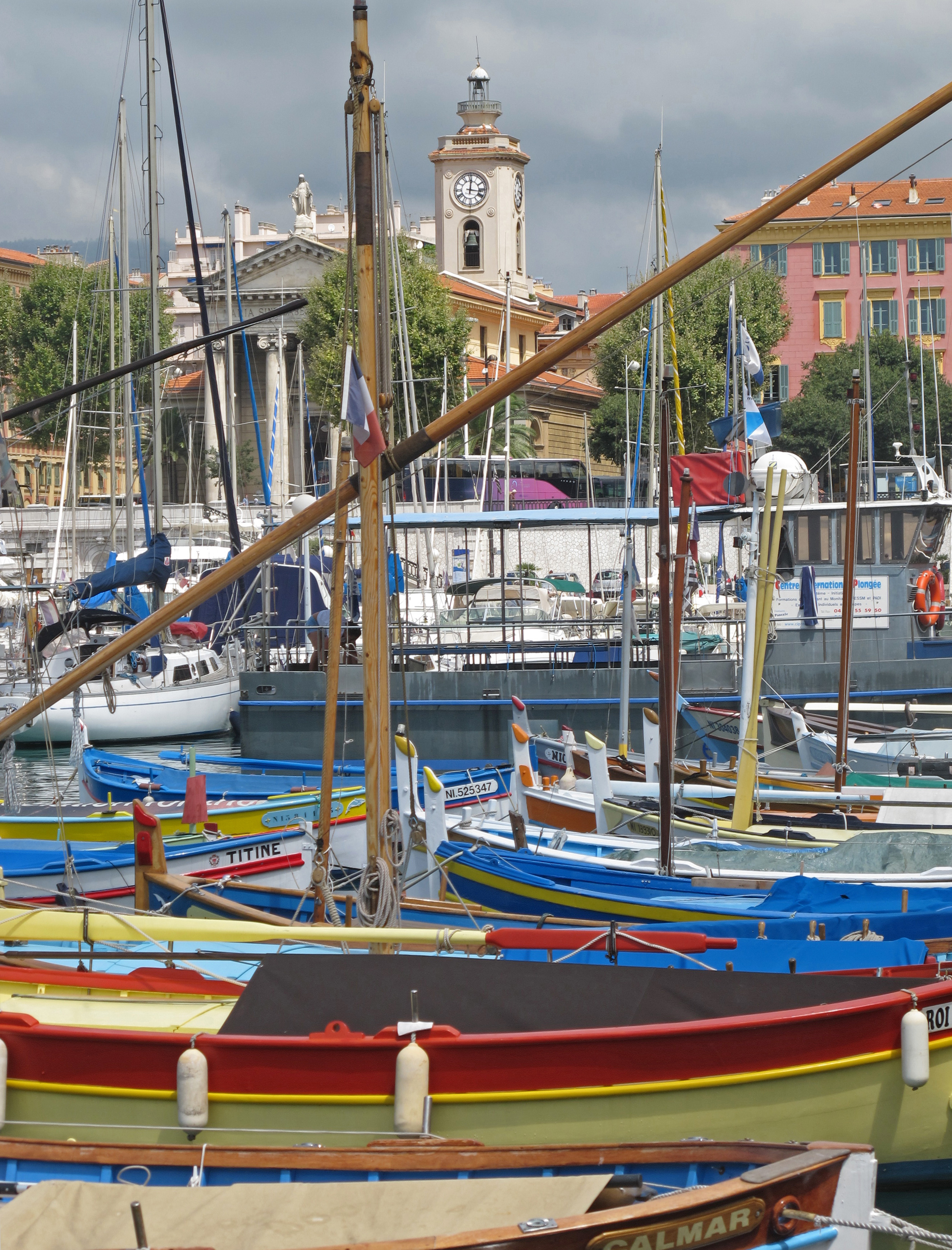 Port of Nice with boats and pastel harborfront buildings