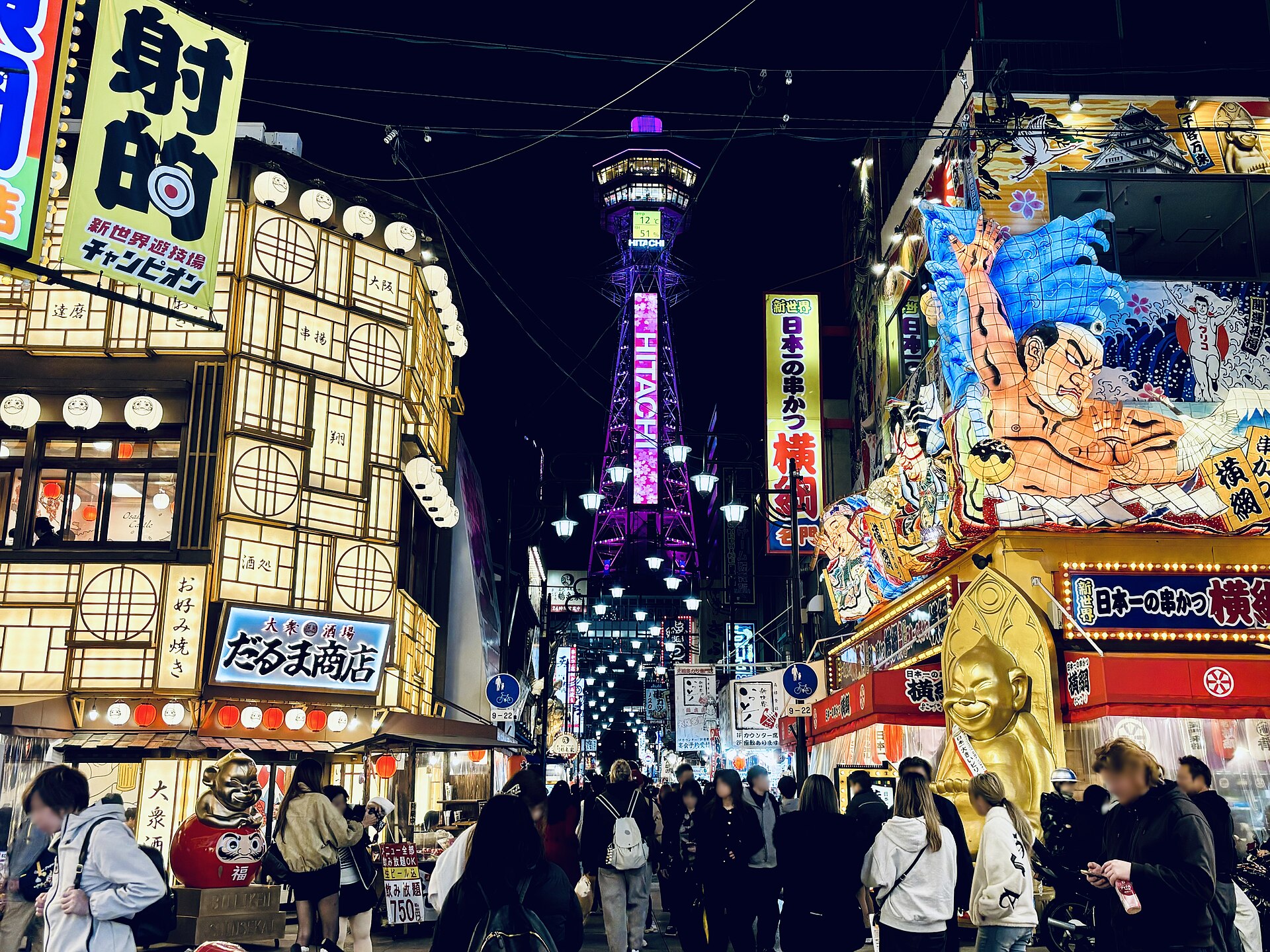 Tsutenkaku rising above the Shinsekai district in Osaka at night
