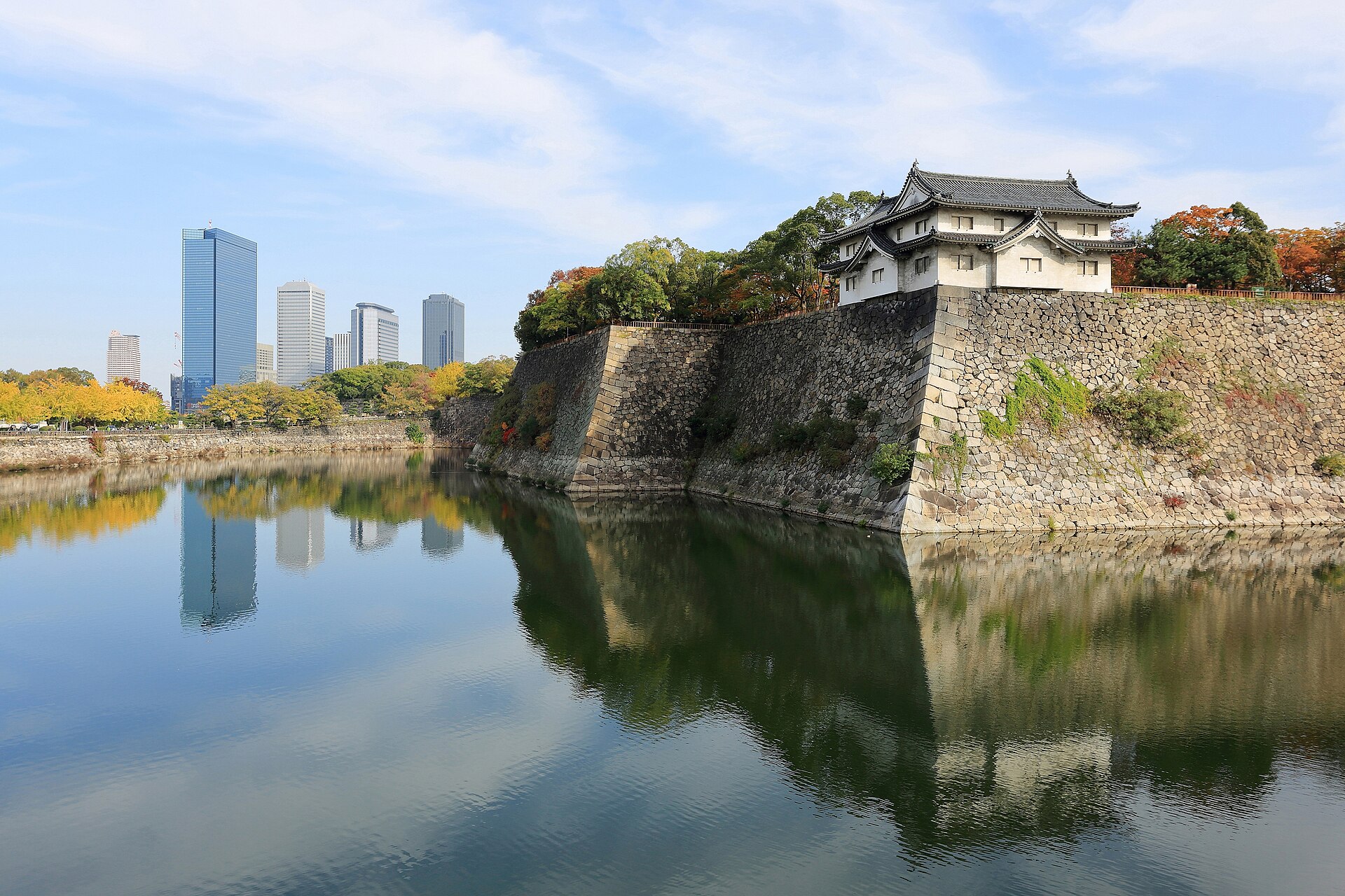 Osaka Castle outer moat with modern Osaka skyline behind it