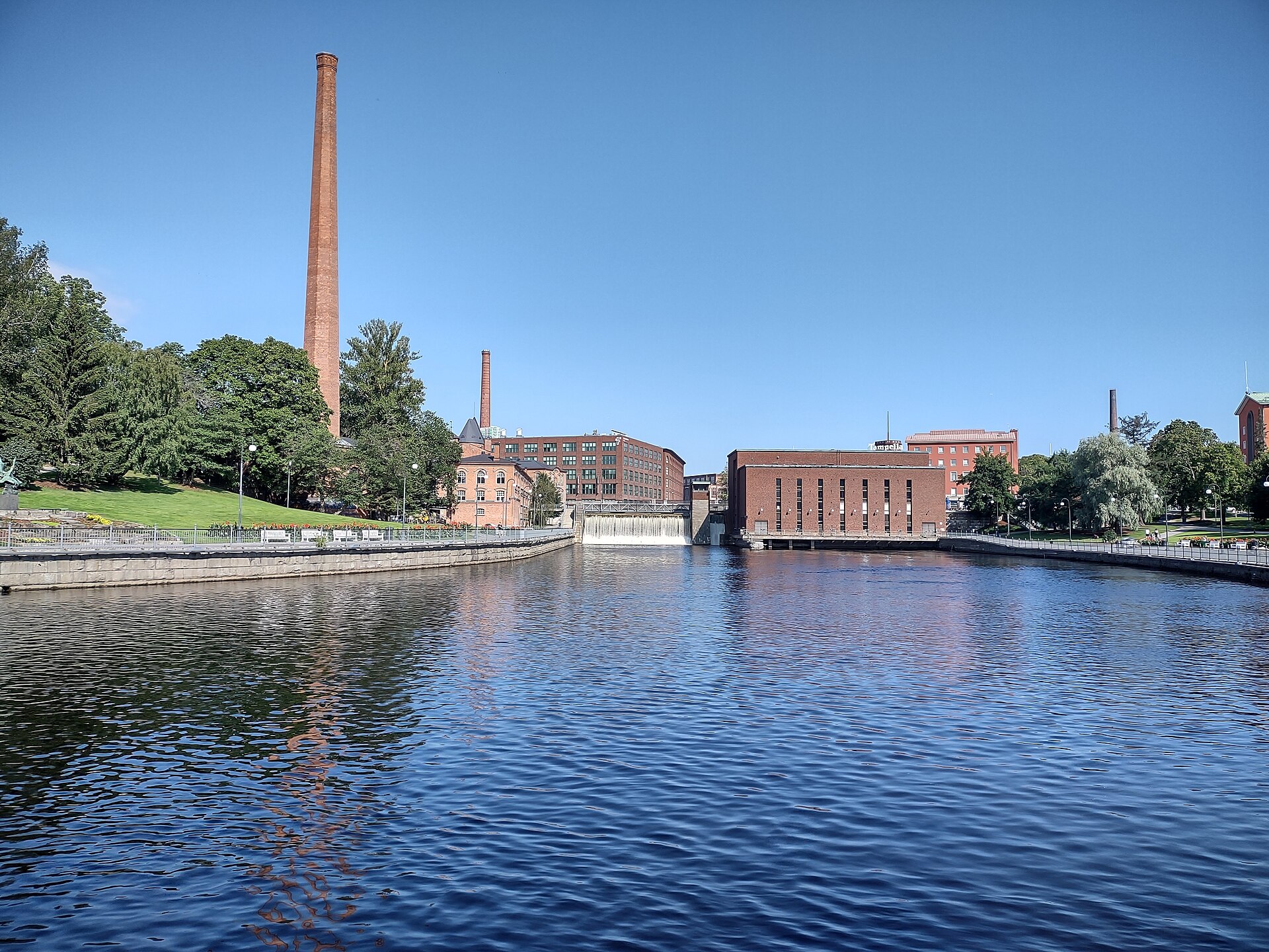 Daytime view of Tammerkoski in Tampere with industrial buildings and water