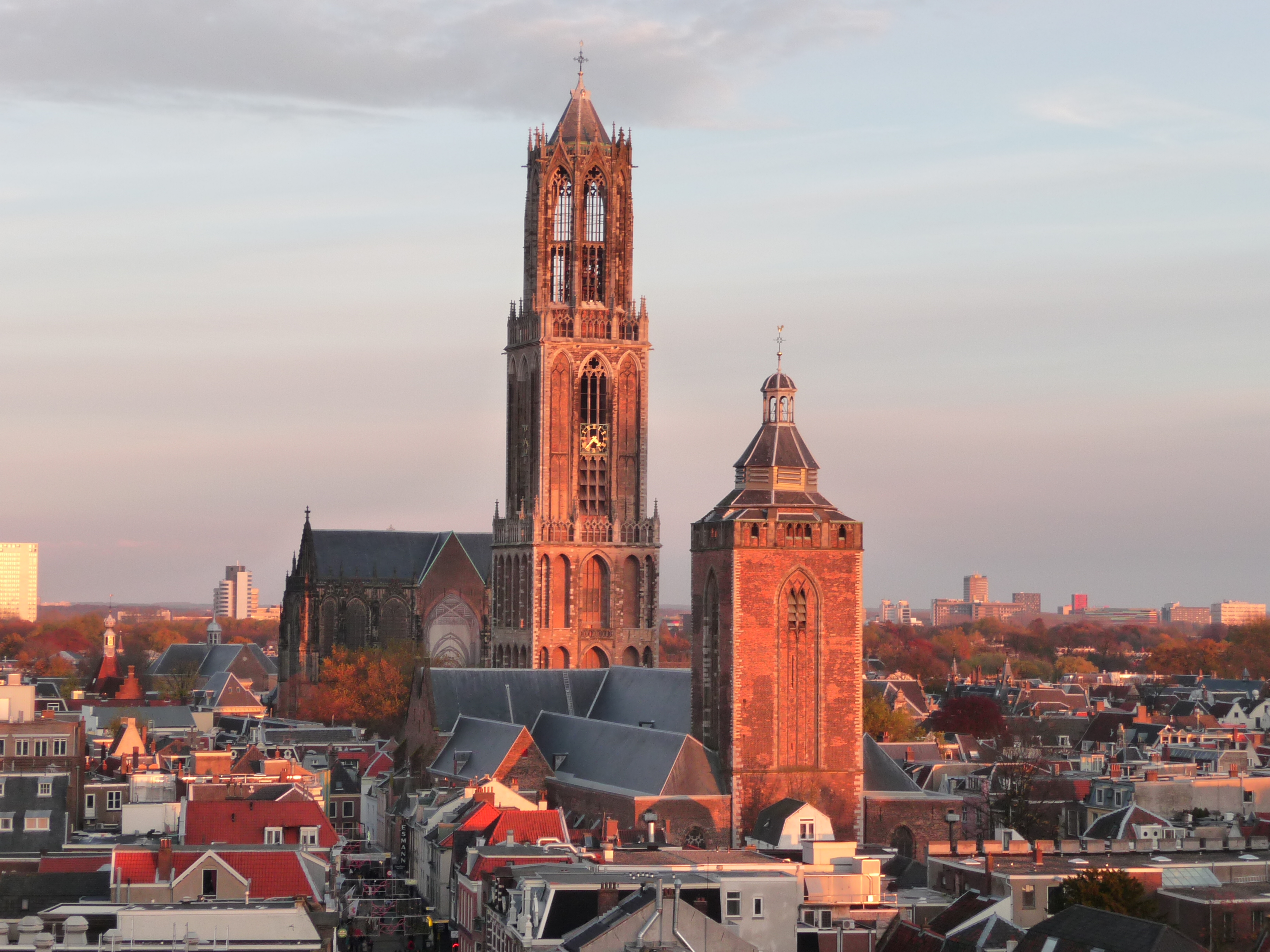 Dom Tower and Buurkerk above Utrecht rooftops at golden hour