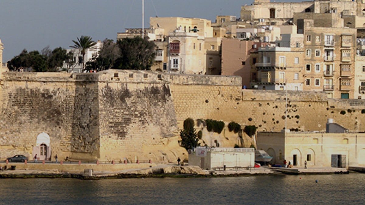 Valletta harbor wall and waterfront buildings seen across the water