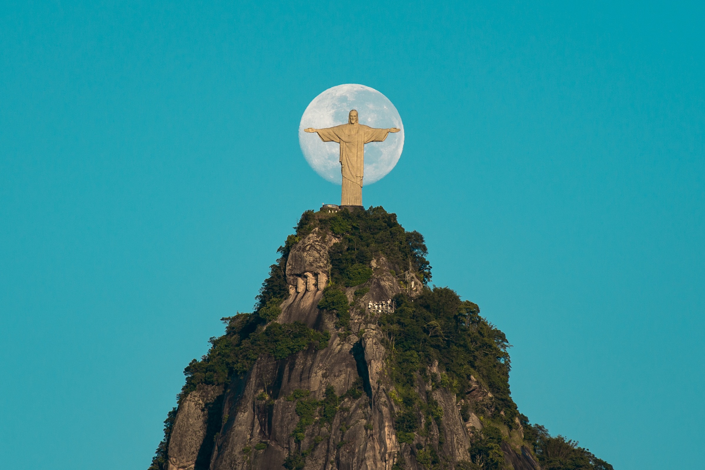 Christ the Redeemer above Rio de Janeiro with the moon behind the statue