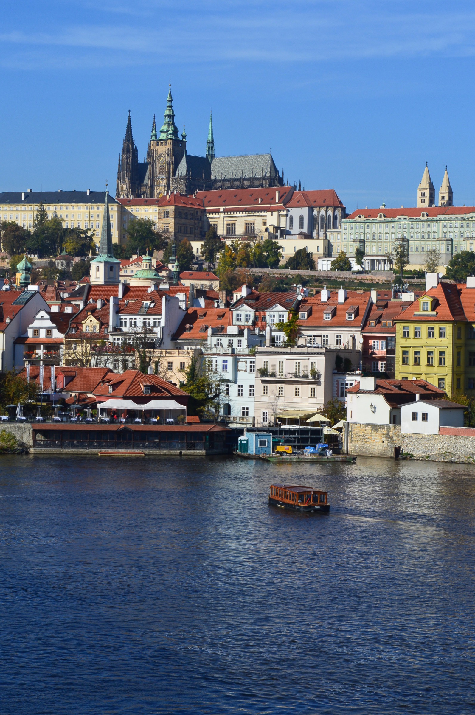 Prague Castle rising above the Vltava and red roofs in Czechia