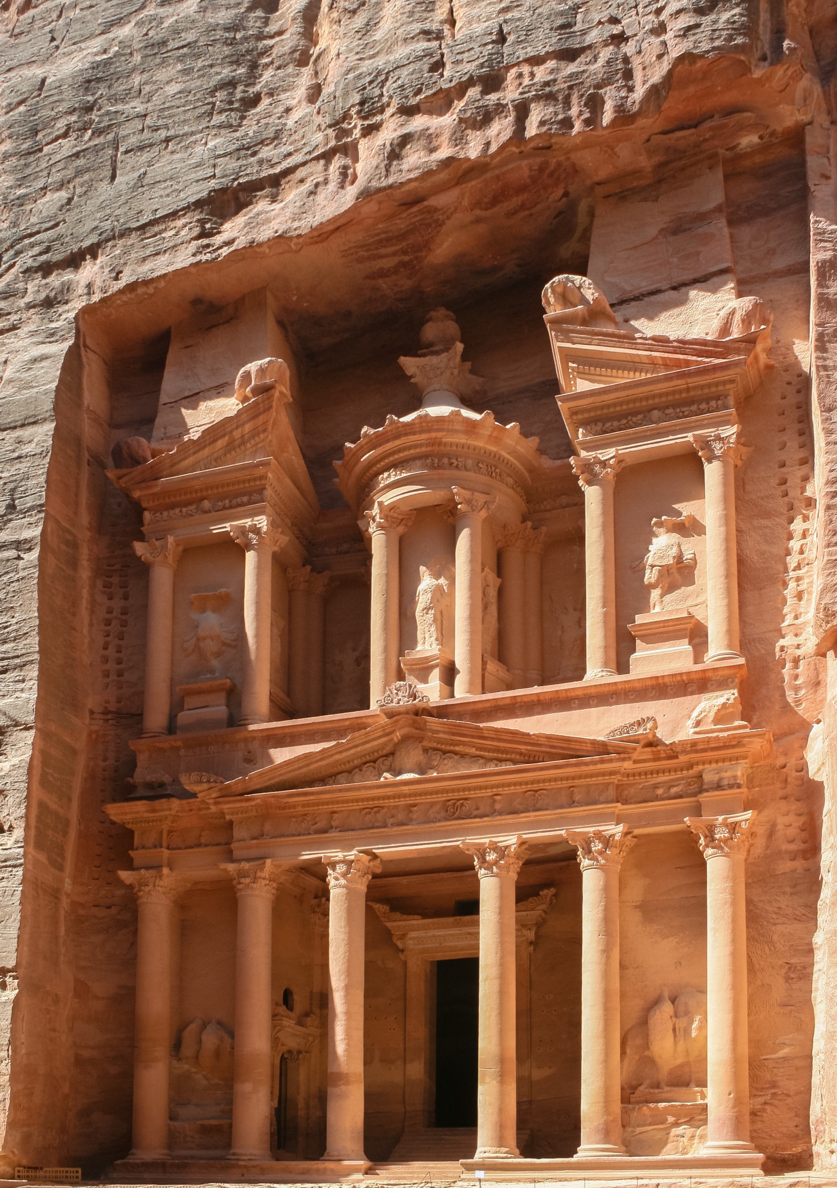 The Treasury facade in Petra with camels resting in front in Jordan