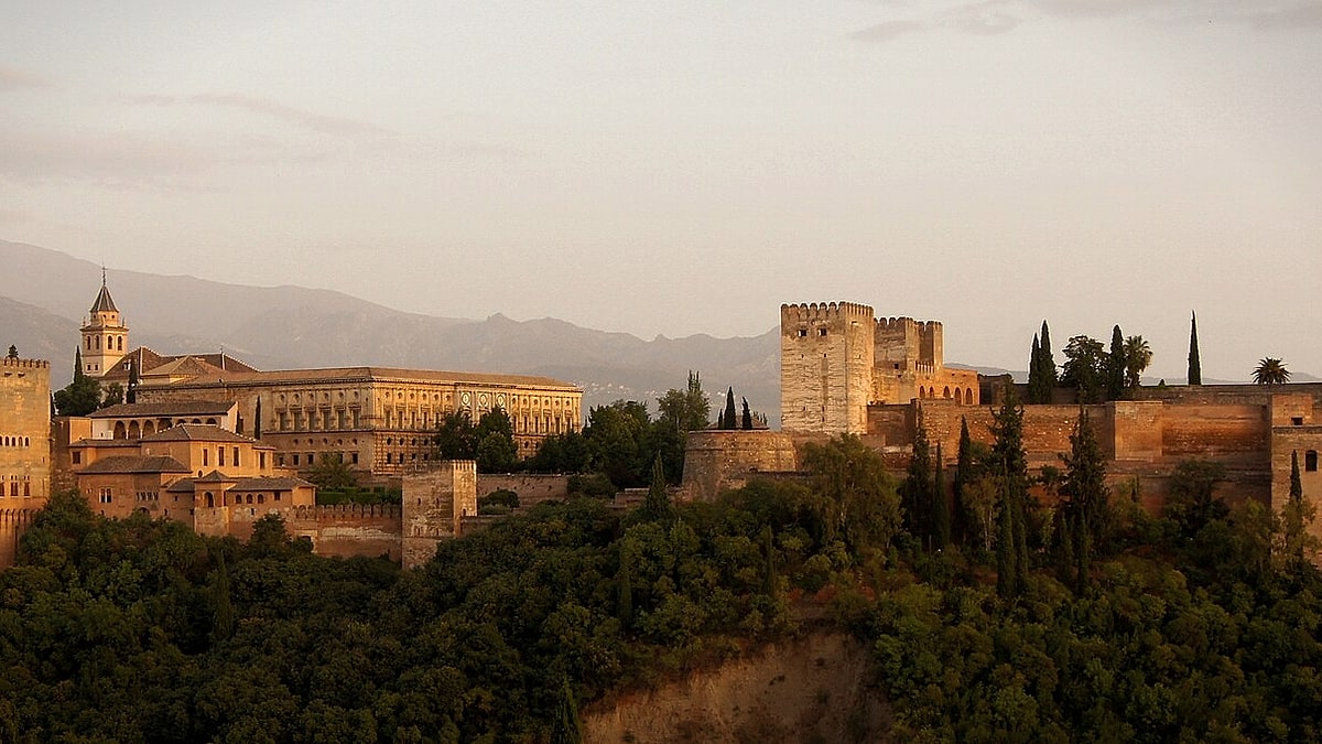 The Alhambra glowing above Granada at dusk in Spain