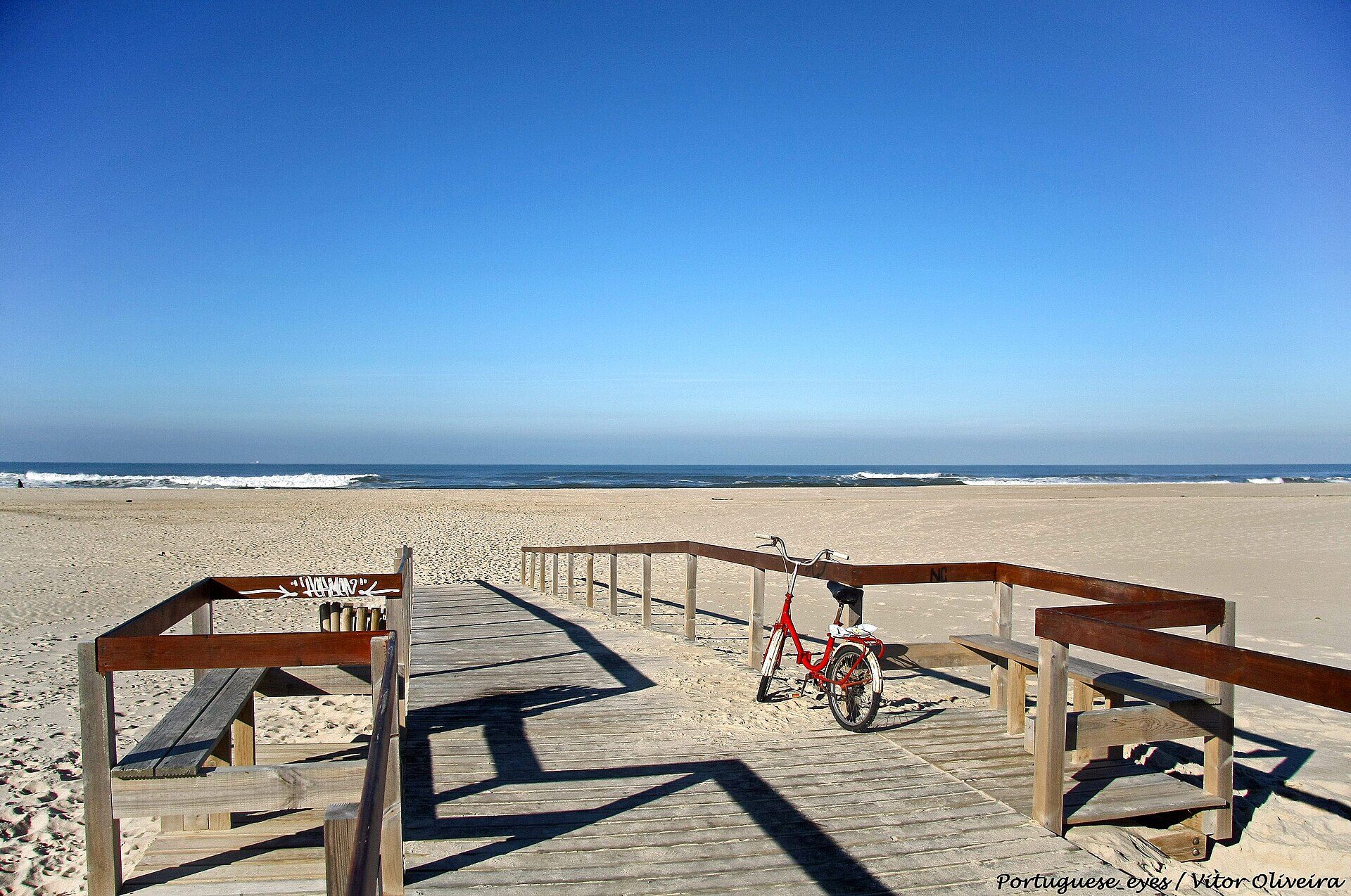 Boardwalk opening onto the wide sand at São Jacinto Beach