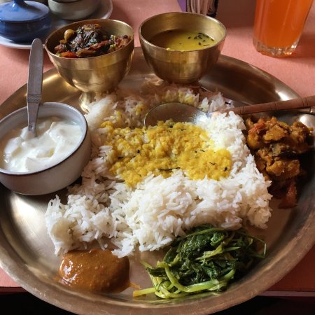 Nepali chicken thali with rice, curries, and pickles