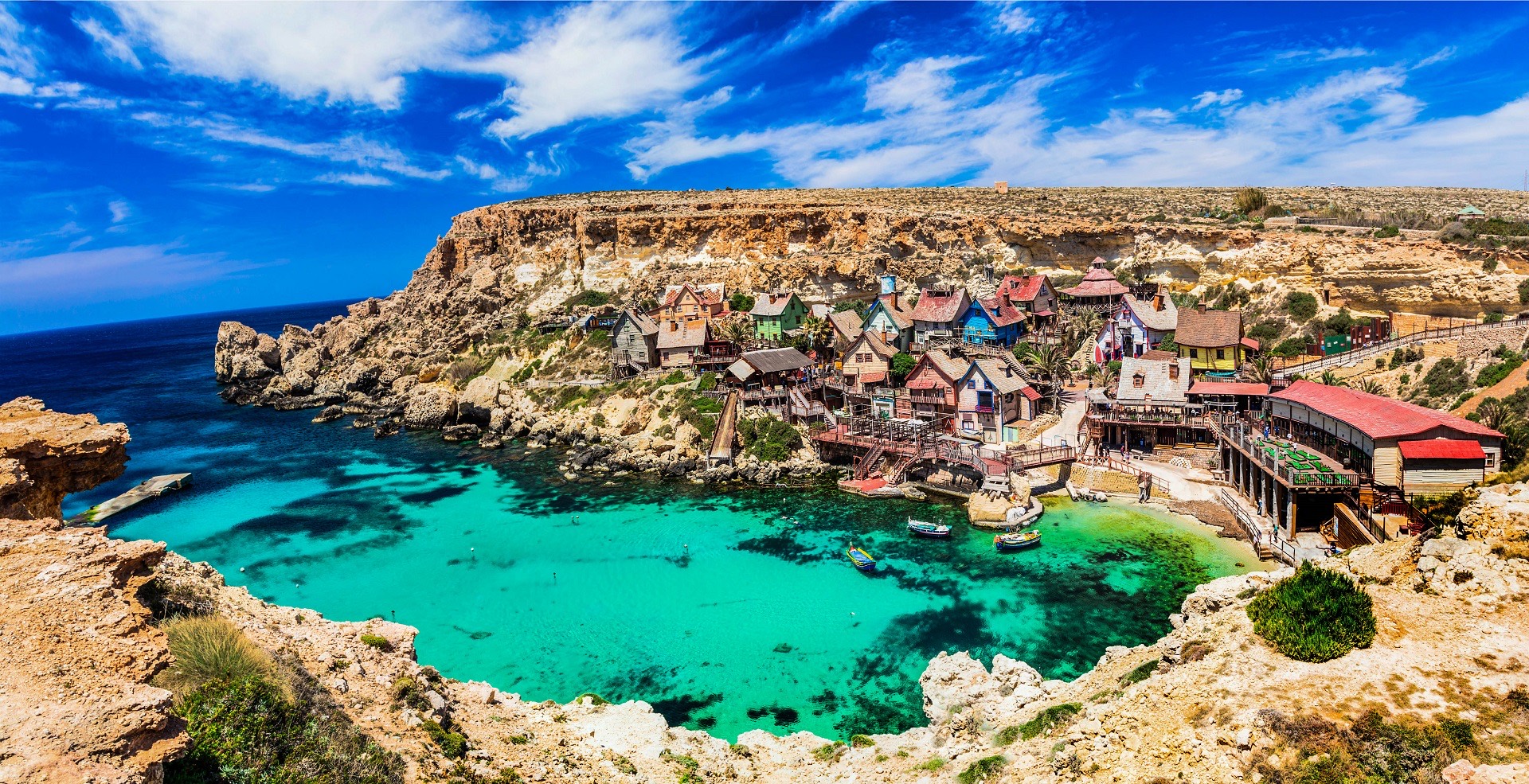 Harbor view across Malta with stone buildings and blue water