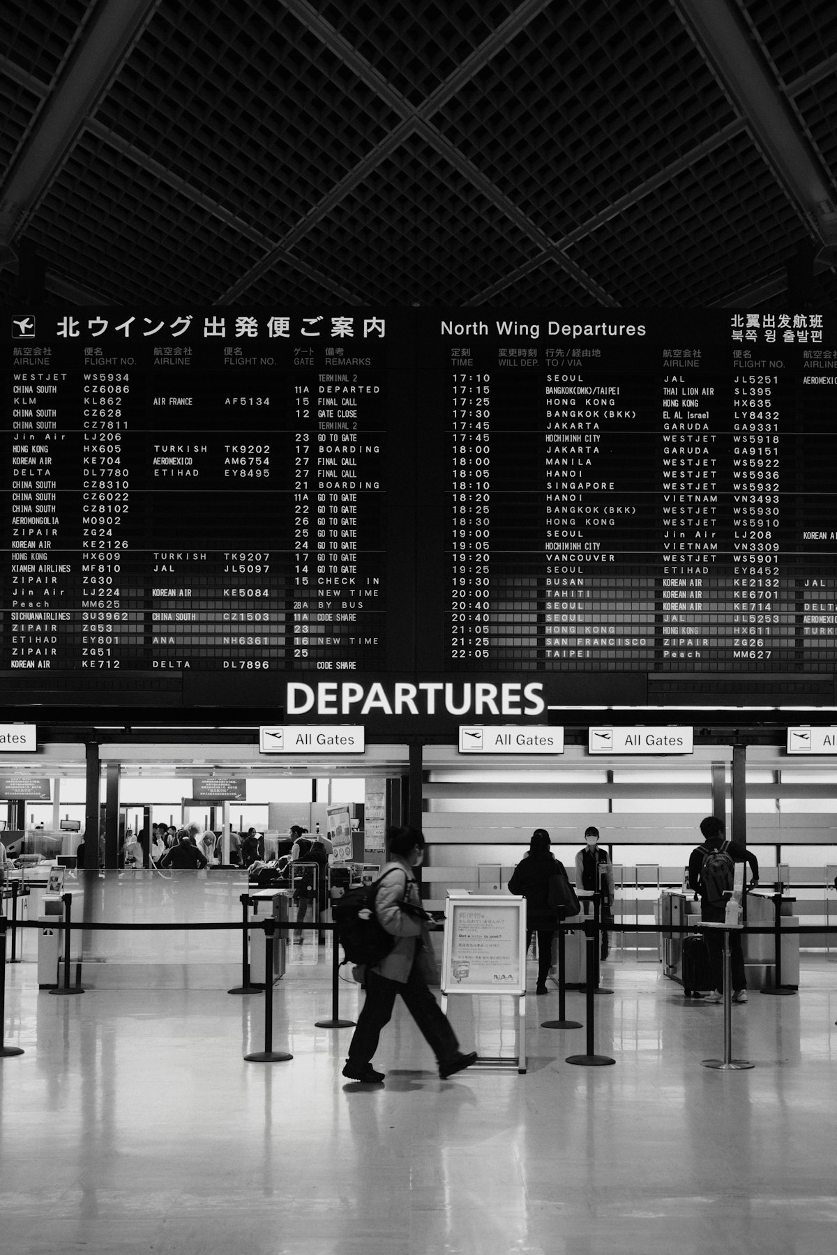 Traveler comparing travel prices on a laptop and phone